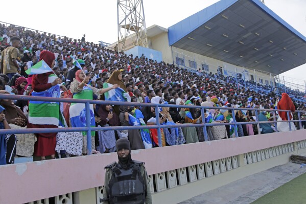 Fans watch the soccer league match between Hirshabele and Jubaland at a stadium in Mogadishu, Somalia, Tuesday, Jan 23, 2024. Somali authorities have in recent years been working to restore the national stadium in Mogadishu. A stadium in the violence-prone Somali capital is hosting its first soccer tournament in three decades, drawing thousands of people to a sports facility that had fallen into disuse and later became a military base amid civil war. (AP Photo/Farah Abdi Warsameh)