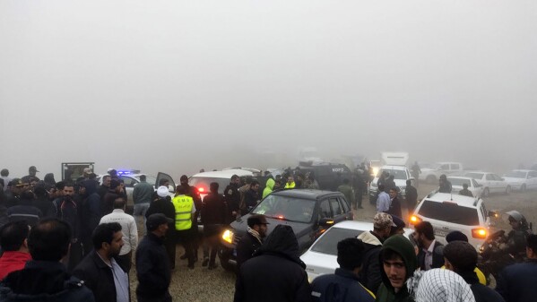 In this photo provided by Moj News Agency, rescue teams and people are seen near the site of the incident of the helicopter carrying Iranian President Ebrahim Raisi in Varzaghan in northwestern Iran, Sunday, May 19, 2024. A helicopter carrying President Raisi, the country's foreign minister and other officials apparently crashed in the mountainous northwest reaches of Iran on Sunday, sparking a massive rescue operation in a fog-shrouded forest as the public was urged to pray. (Azin Haghighi/Moj News Agency via AP)