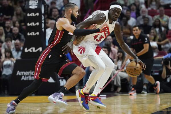 Miami Heat forward Caleb Martin defends Toronto Raptors forward Pascal Siakam (43) during the first half of an NBA basketball game Saturday, Oct. 22, 2022, in Miami. (AP Photo/Marta Lavandier)