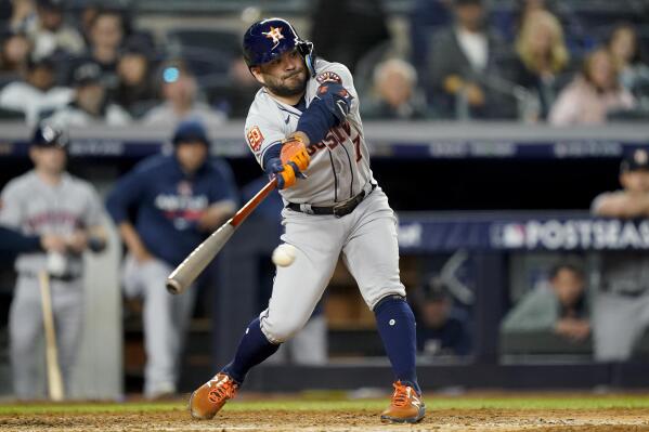 Houston Astros' Jose Altuve (27) connects for a base hit against the New York Yankees during the fifth inning of Game 3 of an American League Championship baseball series, Saturday, Oct. 22, 2022, in New York. (AP Photo/John Minchillo)