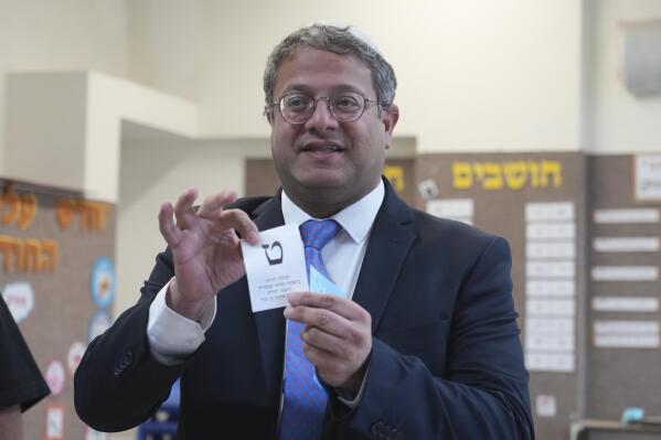 FILE - Israeli far-right lawmaker Itamar Ben Gvir shows his ballot in the West Bank settlement of Kiryat Arba during Israeli elections, Tuesday, Nov. 1, 2022. Ben Gvir, whose surging popularity helped propel former Prime Minister Benjamin Netanyahu back to power in last week's general election, delivered a glowing tribute Thursday, Nov. 10,  at a memorial event for an extremist rabbi assassinated in 1990. (AP Photo/Tsafrir Abayov, File)
