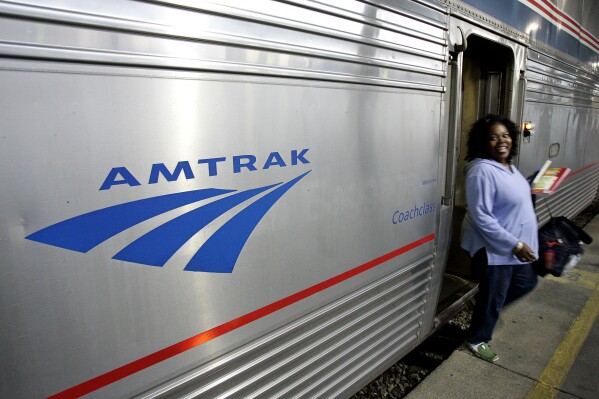 FILE - A passenger disembarks from Amtrak's Sunset Limited at its final stop in New Orleans, Nov. 2, 2008. The Biden administration announced Monday, Sept. 25, 2023, that it has awarded more than $1.4 billion to projects that improve railway safety and boost capacity, with much of the money coming from the 2021 infrastructure law. (AP Photo/Pat Semansky, File)