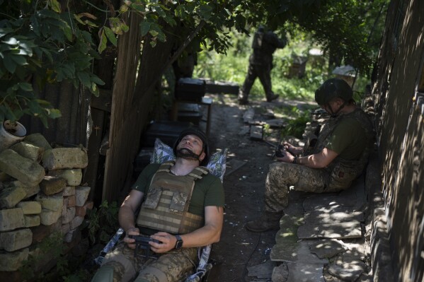 Ukrainian soldiers operate a reconnaissance drone on the front line in the Luhansk Region, Ukraine, Saturday, Aug. 19, 2023. The drone unit's task is to destroy Russia's heavy machinery, armored vehicles and infantry. (AP Photo/Bram Janssen)