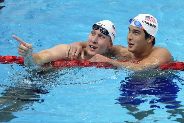 Chase Kalisz, left, of the United States, celebrates with teammate Jay Litherland after winning the final of the men's 400-meter individual medley at the 2020 Summer Olympics, Sunday, July 25, 2021, in Tokyo, Japan. (AP Photo/Petr David Josek)
