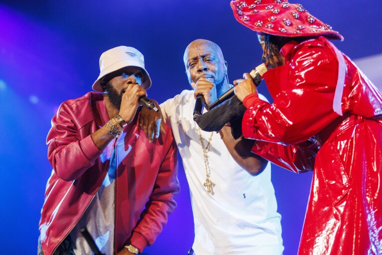 Pras, from left, Wyclef Jean, and Lauryn Hill of the Fugees perform during 