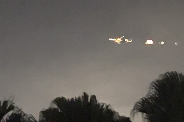 This image taken from video provided by Melanie Adaros shows sparks shooting from a cargo plane before making an emergency landing at Miami International Airport on Thursday, Jan. 18, 2024 in Miami. The aircraft landed safely Thursday night “after experiencing an engine malfunction soon after departure," a spokesperson for Atlas Air said in a statement Friday. “The crew followed all standard procedures and safely returned to MIA." (Melanie Adaros via AP)