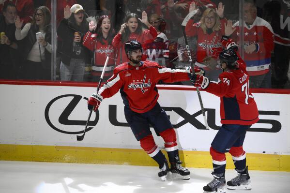 Washington Capitals left wing Marcus Johansson (90) celebrates after his goal with defenseman John Carlson (74) during the third period of an NHL hockey game against the Los Angeles Kings, Saturday, Oct. 22, 2022, in Washington. (AP Photo/Nick Wass)