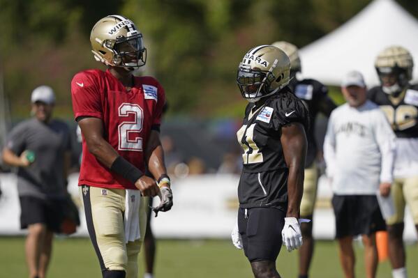 New Orleans Saints quarterback Jameis Winston (2) and running back Alvin Kamara (41) pause between drills during training camp at their NFL football training facility in Metairie, La., Thursday, Aug. 4, 2022. (AP Photo/Gerald Herbert)