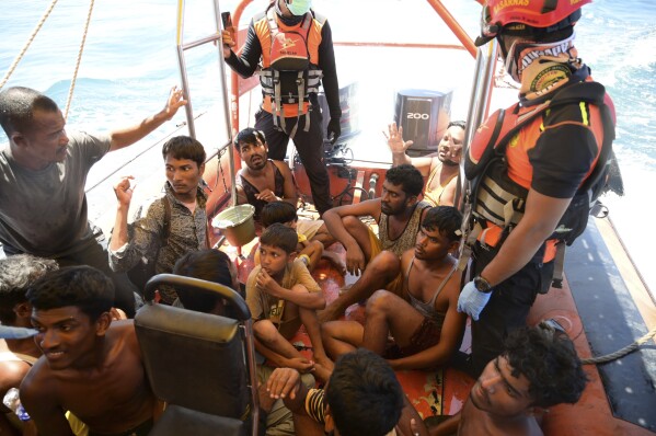 Rohingya refugees rescued from their capsized boat sit in a National Search and Rescue Agency boat in the waters off West Aceh, Indonesia, Thursday, March 21, 2024. A wooden boat carrying dozens of Rohingya Muslims capsized off Indonesia's northernmost coast on Wednesday, according to local fishermen. (AP Photo/Reza Saifullah)