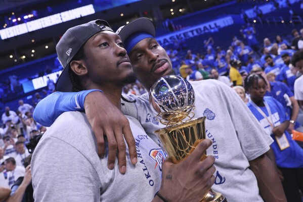 Oklahoma City Thunder forward Jalen Williams (8), left, and Oklahoma City Thunder guard Shai Gilgeous-Alexander (2) pose for a photo after Game 5 of the Western Conference finals of the NBA basketball playoffs against the Minnesota Timberwolves, Wednesday, May 28, 2025, in Oklahoma City. (AP Photo/Nate Billings)