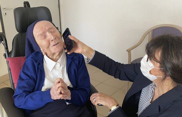 This photo provided by the Sainte-Catherine Laboure care home communications manager shows Lucile Randon, Sister Andre's birth name, speaking on the phone in Toulon, southern France, Thursday, Feb. 11, 2021. Sister Andre, believed to be the world's second-oldest person, was celebrating her 117th birthday in modern style on Thursday. (Sainte-Catherine Laboure care home/ David Tavella via AP)
