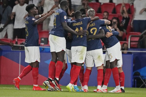 France's Marcus Thuram (15) is mobbed by teammates after scoring during the Euro 2024 Group B qualifying soccer match between France and Ireland at Parc des Princes stadium in Paris, Thursday, Sept. 7, 2023. (AP Photo/Michel Euler)