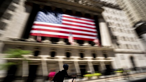 A person bikes past the New York Stock Exchange on Wednesday, June 29, 2022 in New York. Stocks shifted between gains and losses on Wall Street Wednesday, keeping the market on track for its fourth monthly loss this year. (AP Photo/Julia Nikhinson)