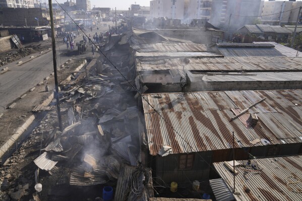 Burnt buildings are seen at a scene of an explosion at an industrial building in Nairobi, Kenya Friday, Feb. 2, 2024. A vehicle loaded with gas exploded and set off an inferno that burned homes and warehouses in Kenya's capital early Friday, injuring multiple people. (AP Photo/Brian Inganga)