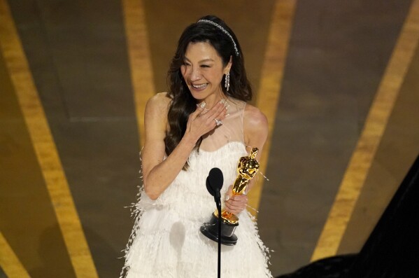 FILE - Michelle Yeoh accepts the award for best performance by an actress in a leading role for "Everything Everywhere All at Once" at the Oscars on Sunday, March 12, 2023, at the Dolby Theatre in Los Angeles. (AP Photo/Chris Pizzello, File)