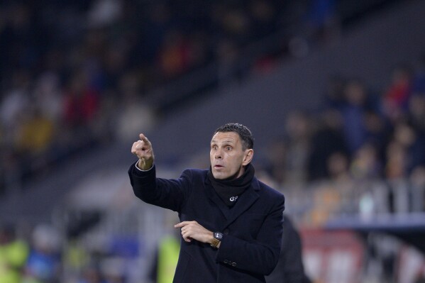 FILE - Greece's head coach Gus Poyet gives instruction from inside the box team area during the international friendly soccer match between Romania and Greece at the National Arena stadium in Bucharest, Romania, Friday, March 25, 2022. Greece advancing into a European Championship with a foreign coach is a soccer tradition Gus Poyet aims to build on. (AP Photo/Alexandru Dobre, File)
