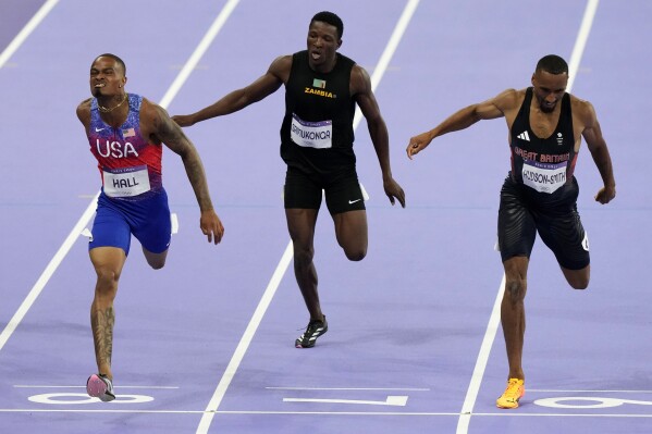Quincy Hall, left, of the United States, beats Matthew Hudson-Smith, right, of Britain, to win the men's 400-meter final at the 2024 Summer Olympics, Wednesday, Aug. 7, 2024, in Saint-Denis, France. (AP Photo/Martin Meissner)