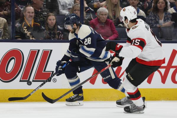 Columbus Blue Jackets' Oliver Bjorkstrand, left, carries the puck up ice as Ottawa Senators' Michael Del Zotto defends during the second period of an NHL hockey game Friday, April 22, 2022, in Columbus, Ohio. (AP Photo/Jay LaPrete)