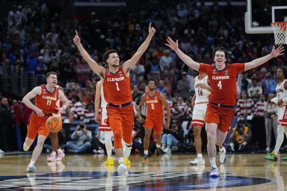 Clemson guard Chase Hunter (1) guard Joseph Girard III (11) and forward Ian Schieffelin (4) celebrate after a win over Arizona in a Sweet 16 college basketball game in the NCAA tournament Thursday, March 28, 2024, in Los Angeles. (AP Photo/Ryan Sun)