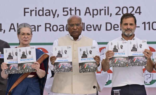 India’s opposition Congress party leaders from left, Sonia Gandhi, Mallikarjun Kharge, and Rahul Gandhi, display copies of party’s election manifesto during a press conference in New Delhi, India, Friday, April 5, 2024. India's 6-week-long general election starts on April 19 and results will be announced on June 4. (AP Photo/Manish Swarup)