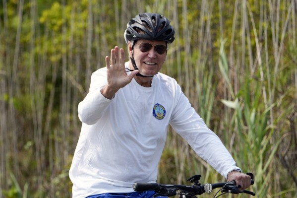 President Joe Biden rides his bike at Gordons Pond in Rehoboth Beach, Del., Tuesday, Aug.1, 2023. (AP Photo/Manuel Balce Ceneta)