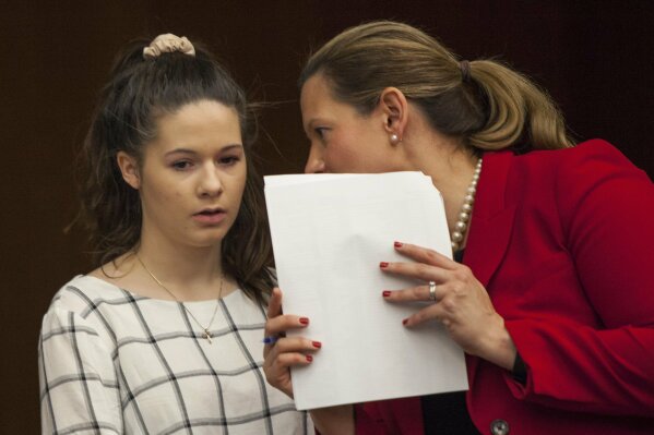 
              Erin Blayer, left, listens to Michigan Assistant Attorney General Angela Povilaitis before giving her statement during Larry Nassar's sentencing at Eaton County Circuit Court in Charlotte on Wednesday, Jan. 31, 2018. The former Michigan State University sports-medicine and USA Gymnastics doctor is being sentenced for three first degree criminal sexual abuse charges related to assaults that occurred at Twistars, a gymnastics facility in Dimondale. Nassar has also been sentenced to 60 years in prison for three child pornography charges in federal court and between 40 to 175 years in Ingham County for seven counts of criminal sexual conduct. (Cory Morse /The Grand Rapids Press via AP)
            