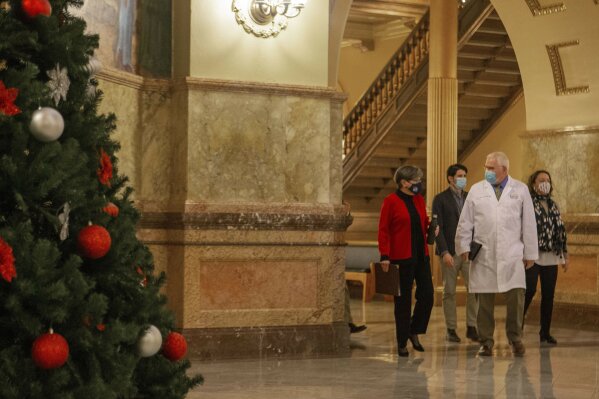 Kansas Gov. Laura Kelly, left, walks with Kansas secretary of health and environment Lee Norman to a news conference, Wednesday, Nov. 25, 2020 at the Statehouse in Topeka, Kan. (Evert Nelson/The Topeka Capital-Journal via AP)