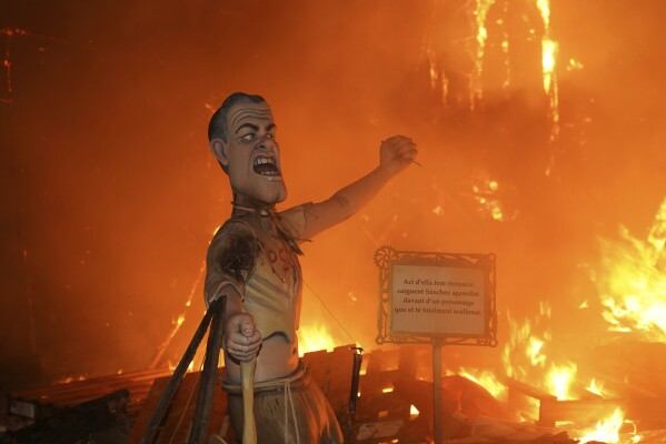 A cardboard sculpture known as a "Ninot" depicting Spain's Prime Minister Pedro Sanchez is engulfed in flames during the Fallas festival in Valencia, Spain, on Wednesday, March 19, 2025. (AP Photo/Alberto Saiz)