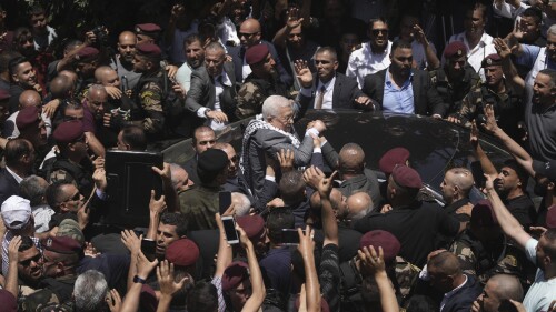 Palestinian President Mahmoud Abbas waves to well-wishers in the Jenin refugee camp in the West Bank, Wednesday, July 12, 2023. Abbas's visit — his first trip to the camp since 2005 — comes a week after a deadly Israeli offensive on Jenin that left widespread destruction in its wake. (AP Photo/Nasser Nasser)