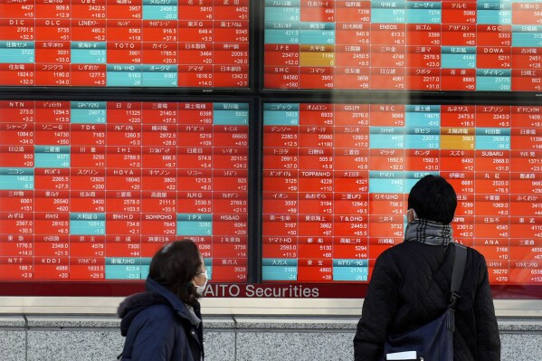 FILE - People look at an electronic stock board showing Japan's stock prices at a securities firm Wednesday, Jan. 17, 2024, in Tokyo. Asian shares were mostly higher Wednesday, Feb. 7, 2024, tracking gains on Wall Street, although Tokyo's benchmark slipped. (APPhoto/Eugene Hoshiko, File)