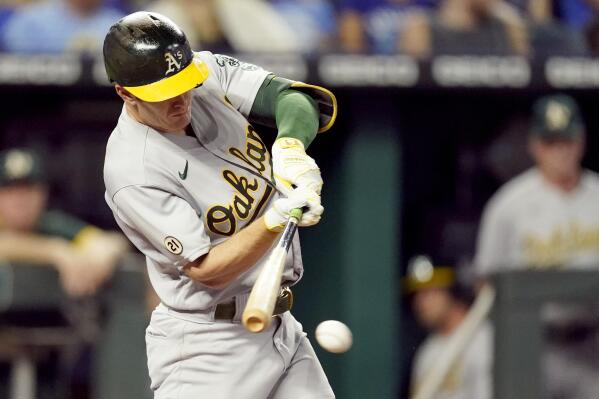 Oakland Athletics' Mark Canha hits an RBI single during the third inning of a baseball game against the Kansas City Royals Wednesday, Sept. 15, 2021, in Kansas City, Mo. (AP Photo/Charlie Riedel)