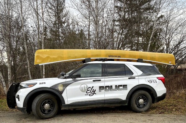 This photo provided by the Ely, Minn., Police Department shows a Kevlar canoe on top of a squad car, Nov. 16, 2023, in Ely, Minn. The police department in the remote north woods Minnesota town of Ely has faced the same challenges of recruiting and keeping new officers as countless other law enforcement agencies around the country, but it's offering a unique incentive: canoes. (Chad Houde/Ely Police Department via AP)