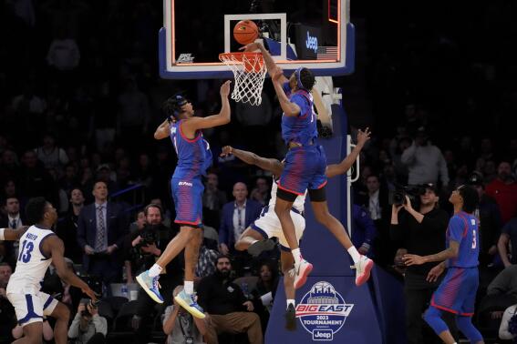 DePaul's Nick Ongenda (14) blocks a last second shot by Seton Hall's Femi Odukale (21) in the second half of an NCAA college basketball game during the first round of the Big East conference tournament, Wednesday, March 8, 2023, in New York. (AP Photo/John Minchillo)