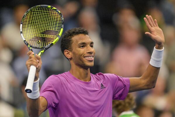 Canada's Felix Auger-Aliassime cheers after winning his seminfinal match against Spain's Carlos Alcaraz at the Swiss Indoors tennis tournament at the St. Jakobshalle in Basel, Switzerland, on Saturday, October 29, 2022. (Georgios Kefalas/Keystone via AP)