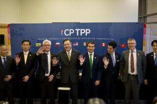 FILE - In this May 16, 2019, file photo, from left, Vietnam's Deputy Minister of Industry and Trade Tran Quoc Khanh, Singapore's Industry and Trade Minister Chan Chun Sing, Canada's Minister of International Trade Diversification James Carr, Chilean Foreign Minister Fernando Ampuero, Chilean Deputy Minister of Trade Rodrigo Yanez, Japan's Parliamentary Vice Minister of Foreign Affairs Kiyoto Tsuji, New Zealand's Minister for Trade and Export Growth David Parker, and Japan's Parliamentary Vice Minister of Economy, Trade and Industry Akimasa Ishikawa, wave as they pose for the group photo after a meeting of the Comprehensive and Progressive Agreement for Trans-Pacific Partnership, CP TPP, in Santiago, Chile. Beijing said Wednesday, Sept. 29, 2021, that it will block Taiwan's application to join a Pacific Rim trade initiative, citing as its reason the island's refusal to concede that it is a part of China. (AP Photo/Esteban Felix, File)