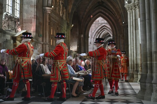 Yeomanry guards carry the bowls containing the red and white purses with the Maundy money inside in Worcester Cathedral, in Worcester Cathedral, Worcester, England, Thursday, March 28, 2024. Maundy Thursday is the Christian holy day falling on the Thursday before Easter. The monarch commemorates Maundy by offering 'alms' to senior citizens. Each recipient receives two purses, one red and one white. (Justin Tallis, Pool Photo via AP)