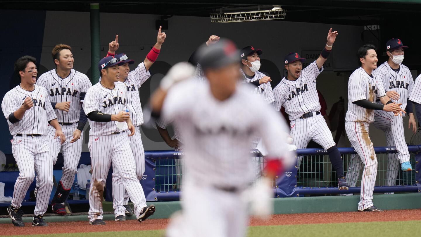 Baseball-Late rally lifts Japan over Dominican team to open Games