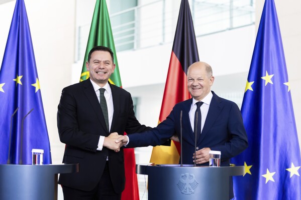German Chancellor Olaf Scholz, right, shakes hands with Prime Minister of Portugal Luis Montenegro during a joint press conference following talks at the Federal Chancellery, in Berlin, Friday May 24, 2024. (Christoph Soeder/dpa via AP)
