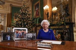 In this image released Tuesday Dec. 24, 2019, Britain's Queen Elizabeth II poses for a photo, while recording her annual Christmas Day message to the nation, at Windsor Castle, England.  Excerpts released by Buckingham Palace of the pre-recorded message to be broadcast on TV on Christmas Day, show the Queen acknowledging that both Britain and her family have endured a difficult year. (Steve Parsons/pool via AP)