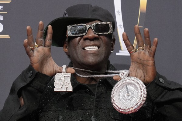 Flavor Flav poses on the red carpet at the NFL Honors award show ahead of the Super Bowl 58 football game Thursday, Feb. 8, 2024, in Las Vegas. (AP Photo/Charlie Riedel)