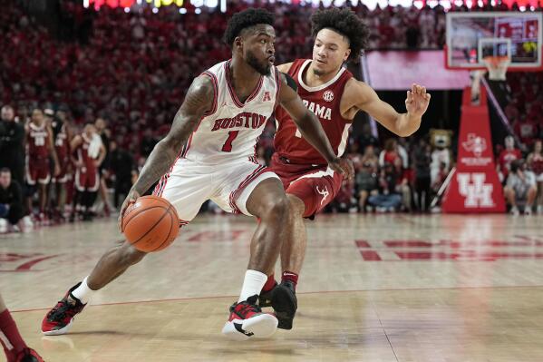 Houston guard Jamal Shead (1) drives past Alabama guard Mark Sears (1) on his way to score during the second half of an NCAA college basketball game, Saturday, Dec. 10, 2022, in Houston. (AP Photo/Kevin M. Cox)
