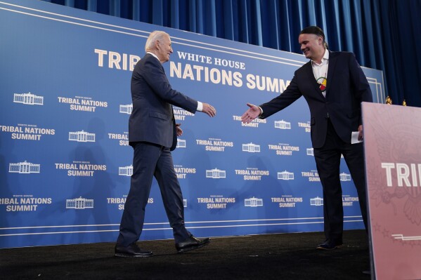 President Joe Biden shakes hands with Assistant Secretary-Indian Affairs Bryan Newland, Department of the Interior, as he arrives to speak at the White House Tribal Nations Summit at the Department of the Interior, Wednesday, Dec. 6, 2023, in Washington. (APPhoto/Evan Vucci)