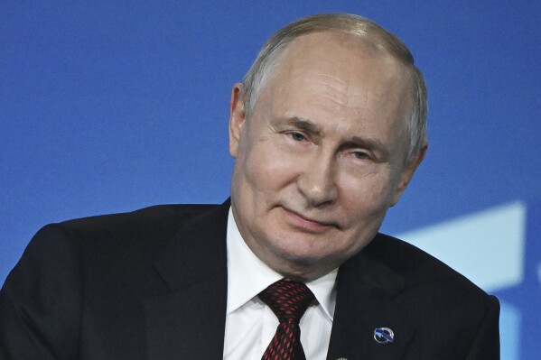 Russian President Vladimir Putin smiles as he answers a question during the annual meeting of the Valdai Discussion Club in the Black Sea resort of Sochi, Russia, Thursday, Oct. 5, 2023. (Sergei Guneyev, Sputnik, Kremlin Pool Photo via AP)