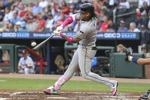 Arizona Diamondbacks' Ketel Marte hits a two-run home run in the third inning of a baseball game against the Atlanta Braves, Tuesday, June 3, 2025, in Atlanta. (AP Photo/Colin Hubbard)