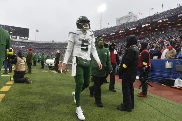 New York Jets quarterback Mike White (5) walks to the locker room during the second half of an NFL football game against the Buffalo Bills, Sunday, Dec. 11, 2022, in Orchard Park, N.Y. As a precaution, Jets head coach Robert Saleh said White was sent to the hospital after the game to be evaluated. (AP Photo/Adrian Kraus)