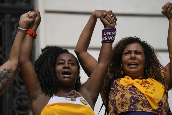 Demonstrators protest against femicide outside the City Council on International Women's Day in Rio de Janeiro, Brazil, Friday, March 8, 2024. (AP Photo/Silvia Izquierdo)