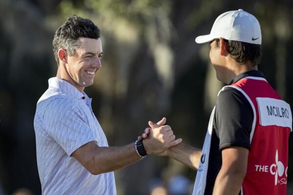 Rory McIlroy, left, of Northern Ireland, left, celebrates with his caddie after the final round of the CJ Cup golf tournament Sunday, Oct. 23, 2022, in Ridgeland, S.C. (AP Photo/Stephen B. Morton)