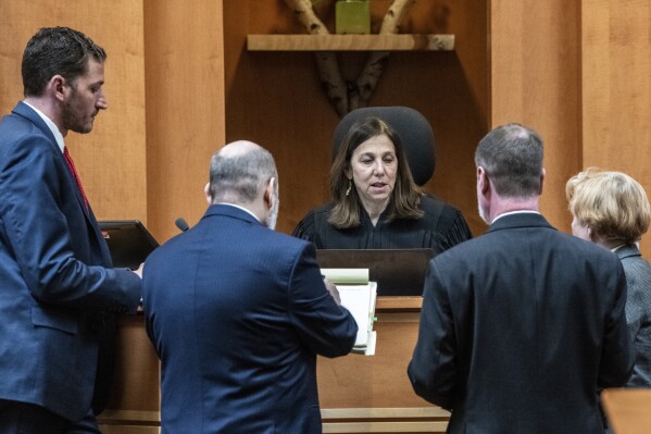 Superior Court Justice Amy Messer talks with the lawyers during the trial of Adam Montgomery at Hillsborough County Superior Court, Thursday, Feb. 22, 2024, in Manchester, N.H. Montgomery has been convicted of second-degree murder in the death of his 5-year-old daughter. Police believe Harmony Montgomery was killed nearly two years before she was reported missing in 2021. (Jeffrey Hastings/Pool Photo via AP)