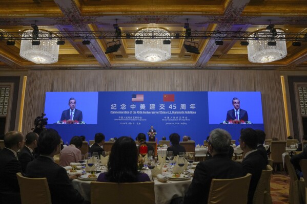 Chinese Foreign Minister Wang Yi speaks on stage during a reception for Commemoration of the 45th Anniversary of China-U.S. Diplomatic Relations at the Diaoyutai Guest House in Beijing, Friday, Jan. 5, 2024. (AP Photo/Andy Wong, Pool)