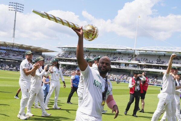 South Africa's captain Temba Bavuma celebrates with the winner's trophy after their win in the World Test Championship final against Australia at Lord's cricket ground in London, Saturday, June 14, 2025. (AP Photo/Kirsty Wigglesworth)